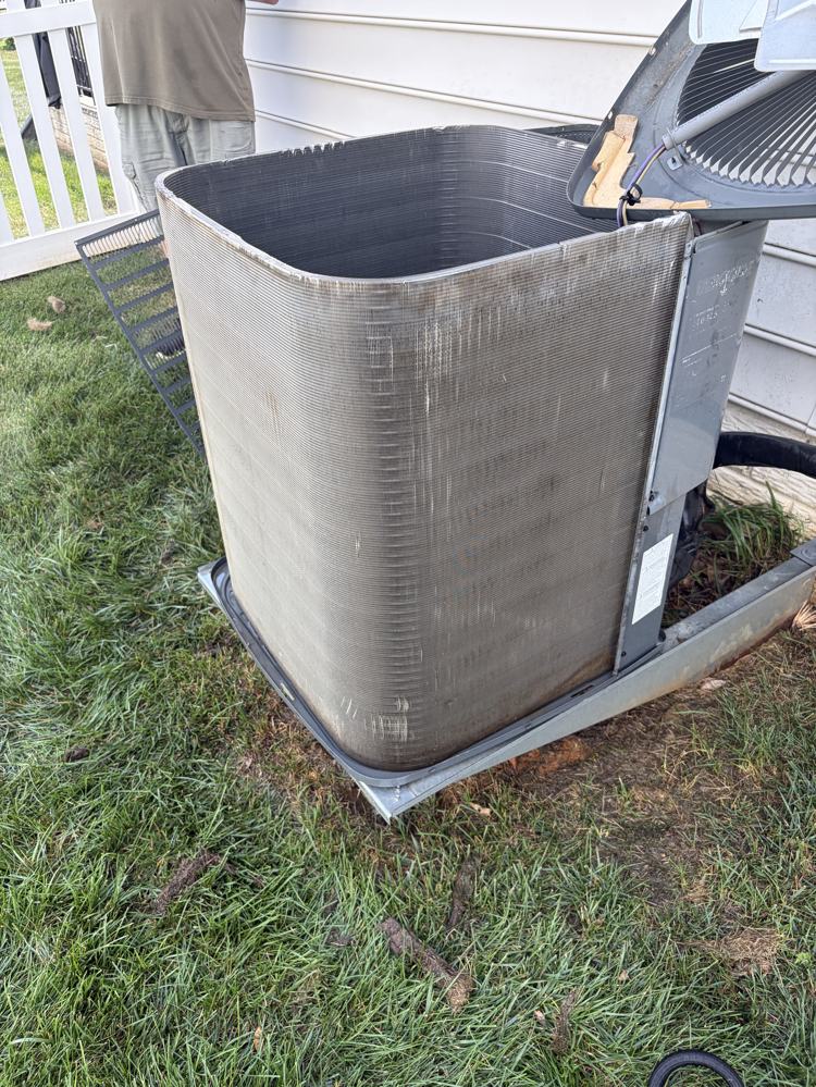 Condenser with panels removed, coil fully exposed mid-service